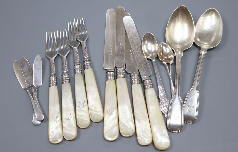 A quantity of silver cutlery, including four mother of pearl handled fruit knives and forks and assorted spoons, 16ozs gross